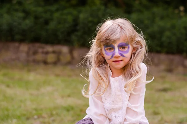 Blond girl with facepainting Royalty Free Stock Photos