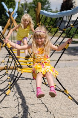 girl on playground climbing