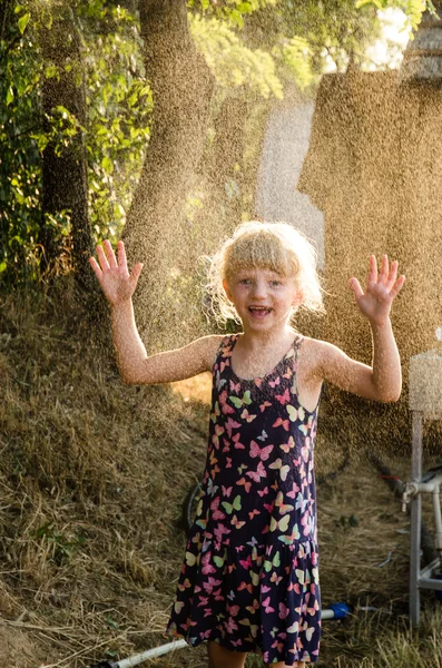 Happy girl in spraying water — Stock Photo, Image