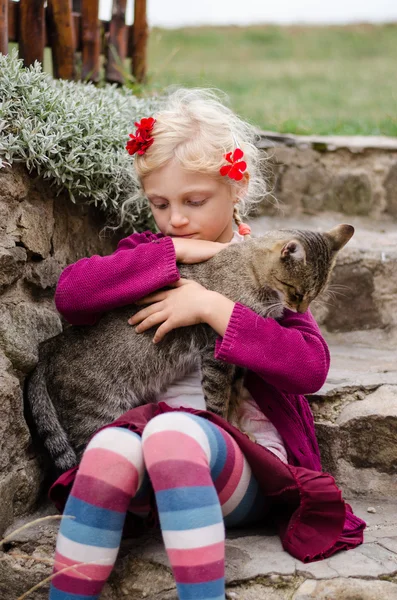 Criança acariciando grande gato — Fotografia de Stock