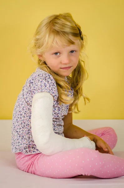 Blond girl with broken hand — Stock Photo, Image