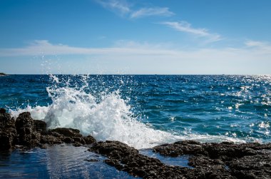 water splash on rocky seaside clipart