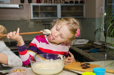 Çocuk bir kepçe yalama