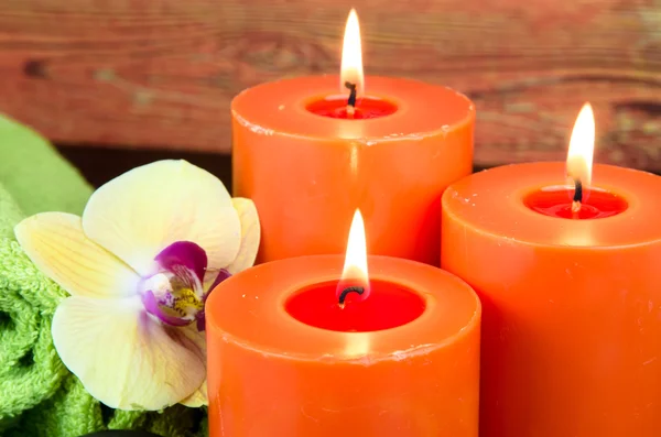 Orange burning candle — Stock Photo, Image