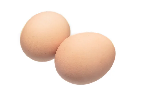 Dwa surowe jaja na białym tle — Zdjęcie stockowe