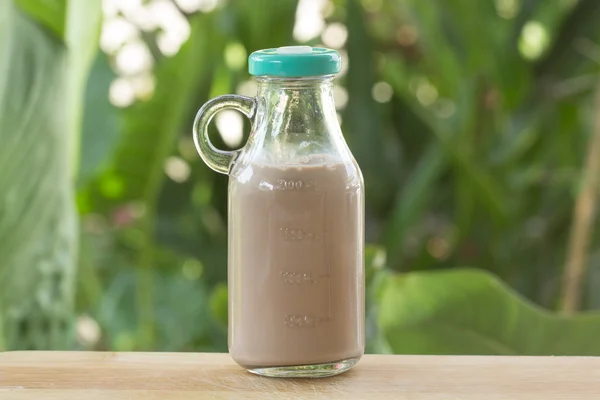 Chocolate milk in glass bottle — Stock Photo, Image