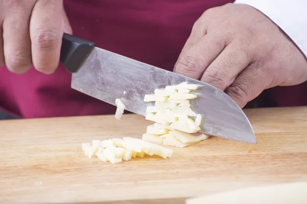 Closed up Chef cutting cheese with knife before cooking — Stock Photo, Image
