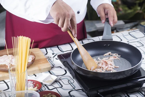 Chef fritando bacon na panela — Fotografia de Stock