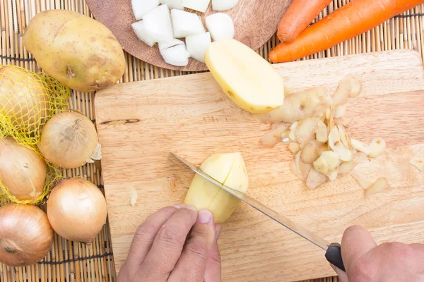Chef cutting Potato with knife — Stock Photo, Image