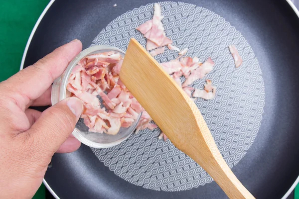 Putting bacon to the pan for fried — Stock Photo, Image