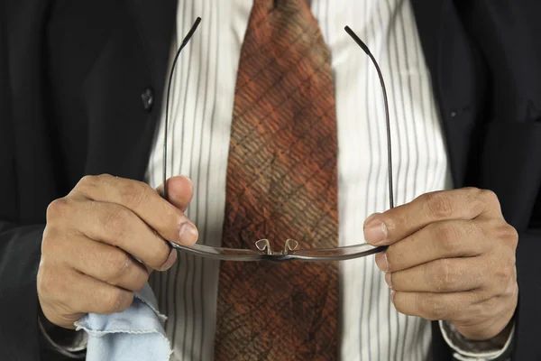 Hands of businessman cleaning glasses — Stock Photo, Image