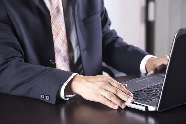 Business man holding Disk insert to laptop — Stock Photo, Image