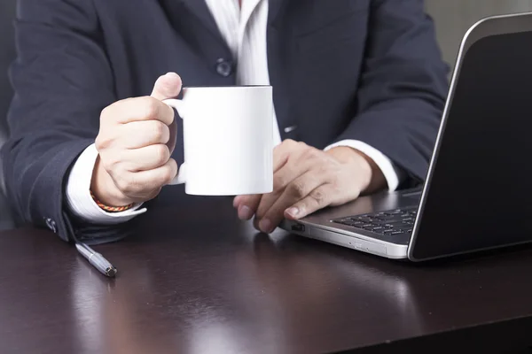 Businessman holding cup of coffee — Stock Photo, Image