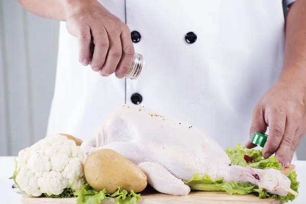 Chef shaking a seasoning — Stock Photo, Image