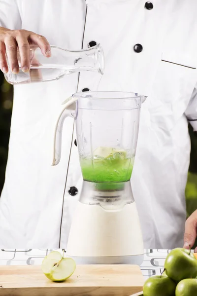 Pouring water for making green apple smoothie — Stock Photo, Image