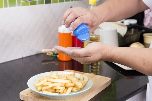 Chef prepared putting salt to French Fired — Stock Photo, Image