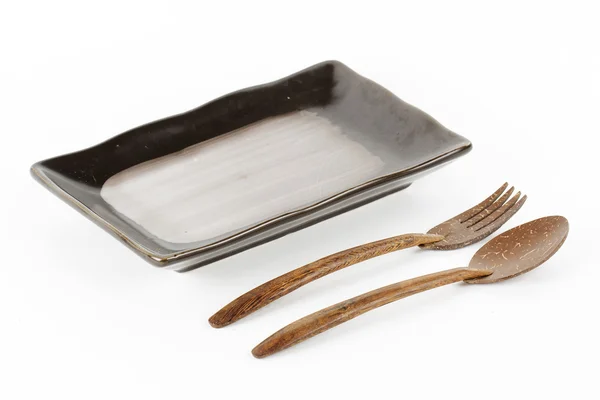 Black ceramic plate with spoon and fork — Stock Photo, Image