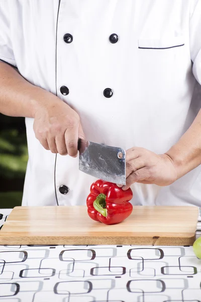 Chef cutting red bell pepper — Stock Photo, Image