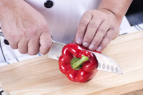 Chef cutting red bell pepper — Stock Photo, Image