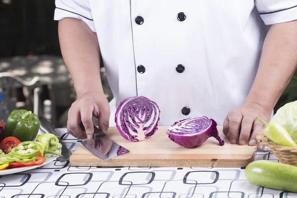 Шеф-кухар, що ріже фіолетову капусту — стокове фото