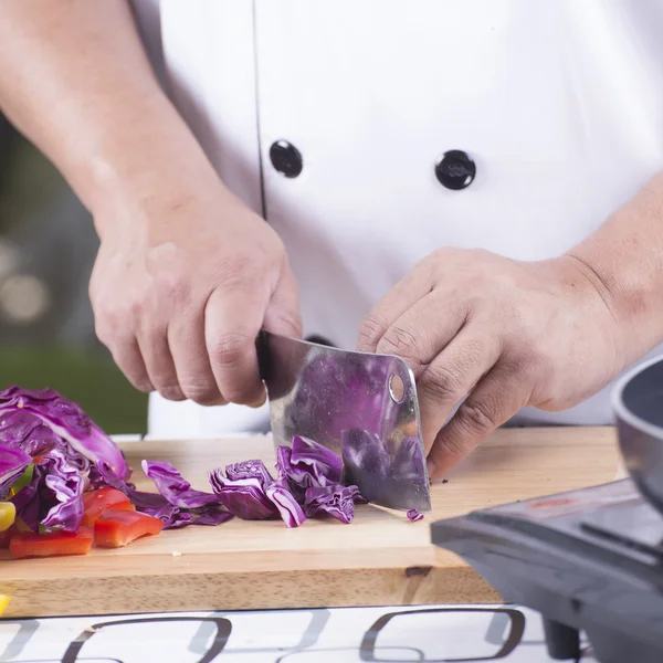 Шеф-кухар, що ріже фіолетову капусту — стокове фото