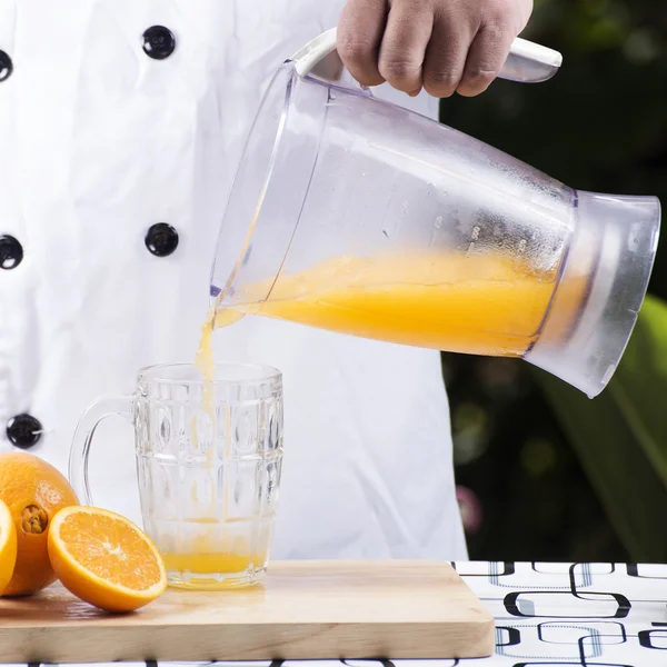 pouring orange juice smoothie