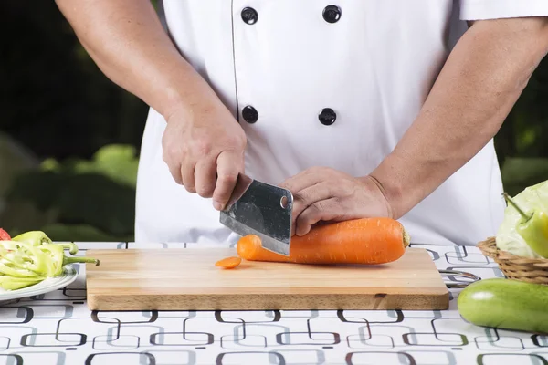 Chef cutting carrot — Stock Photo, Image