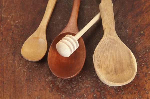 Wooden spoons on a timber board — Stock Photo, Image