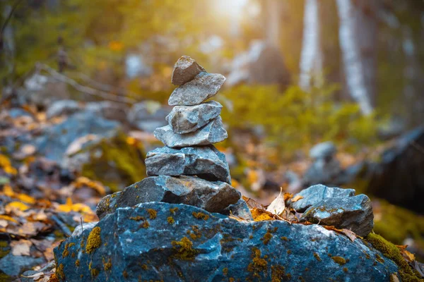 A pile of stones. Cairn close up. Panoramic deep landscape. Rocky northern nature. Man made stone pyramid. Background for relaxation, meditation, contemplation, calming
