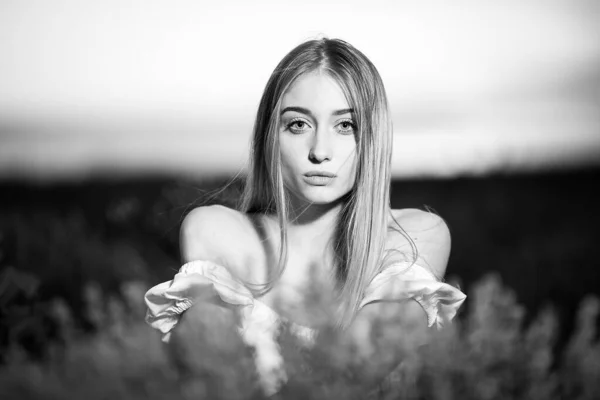 Beautiful blonde woman in the lavender field on sunset. B/W