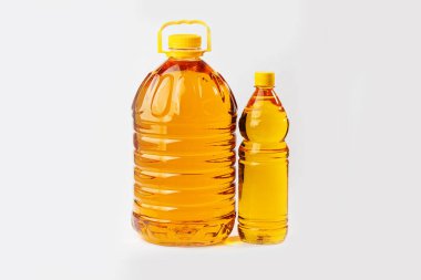 Plastik şişelerdeki ayçiçeği yağı beyaza izole edilmiş..
