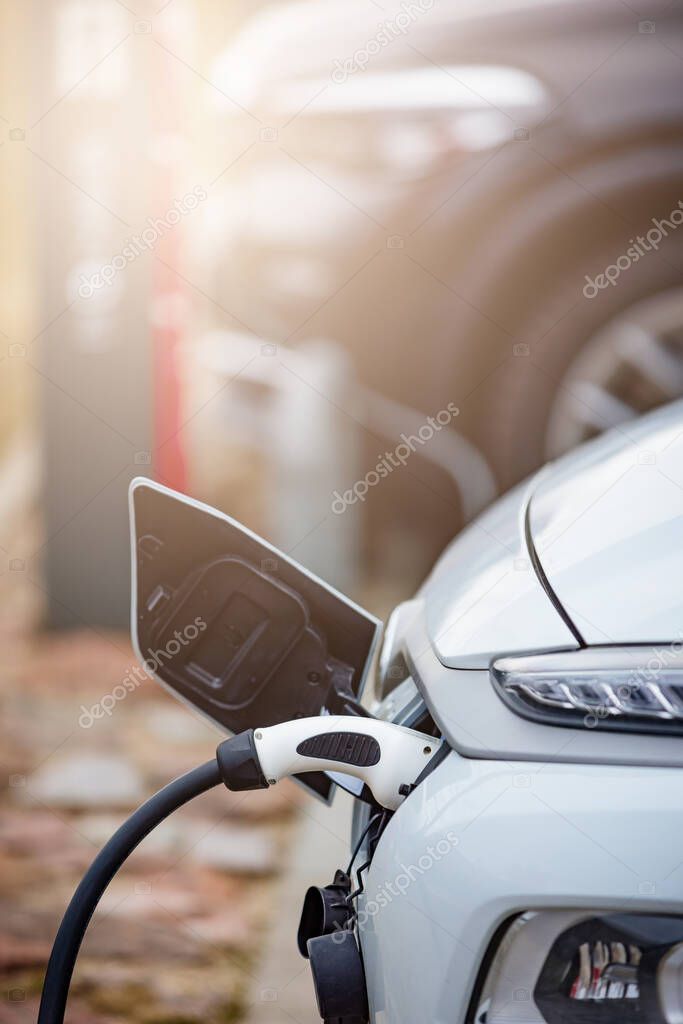 EV Car or Electric car at charging station with the power cable supply plugged in