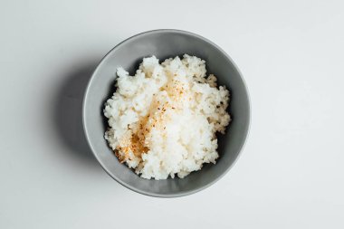 Beyaz pirinç ve parlak arka planda gri kâse.