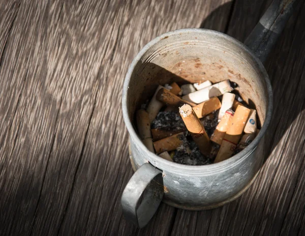 Cigarette with ashtray on wood table. — Stock Photo, Image