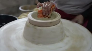 hands working clay on potter's wheel, Lampang in Thailand