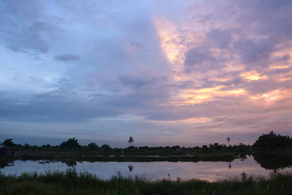 Twilight clouds over the fish pond in Thailand — Stock Photo, Image