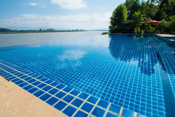 Swimming pool near Khong river with blue sky ,Chiangsan in Chiangrai ,Thailand — Stock Photo, Image