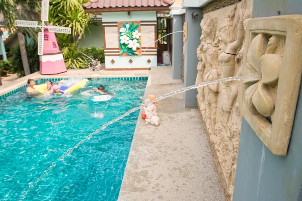 Swimming pool in backyard with fountain — Stock Photo, Image