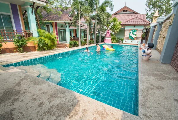 Swimming pool in backyard with fountain — Stock Photo, Image