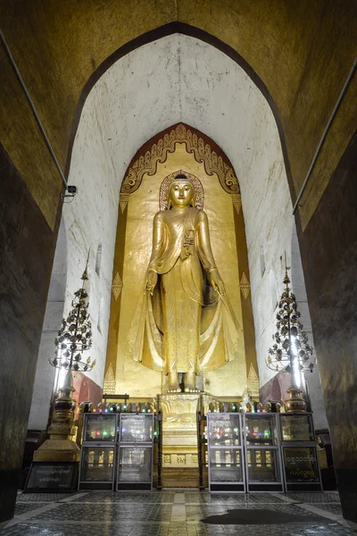 Stående Buddha Kassapa på Ananda templet prydd av troende genom att hålla fast gyllene lämnar på statyn den 30 juli 2015 i Bagan, Myanmar. — Stockfoto