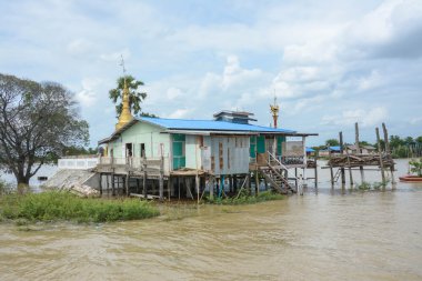 Geleneksel stilts ahşap ve bambu evler ve uzun Ayewadee Mandalay, Myanmar (Burma nehire gemilerde)