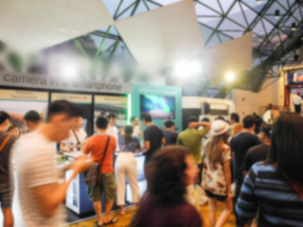 Abstract people walking in exhibition blurred background