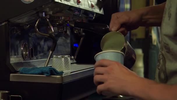 Barista προσθέτοντας γάλα σε latte στο εξωτερικό μπαρ κατά τη διάρκεια αργά το βράδυ — Αρχείο Βίντεο