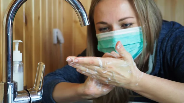 Coronavirus mers. Adorable young woman washing hands thoroughly with foam. Protection from contagious diseases