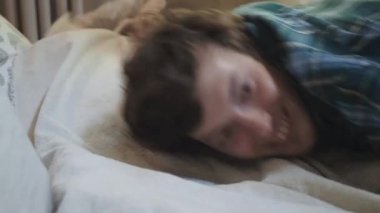 Yorgun genç bir adam yorucu bir günün ardından yatakta uyuyakalıyor. İş adamı yatakta çırpınıyor, evde dinlenmesi gerekiyor..