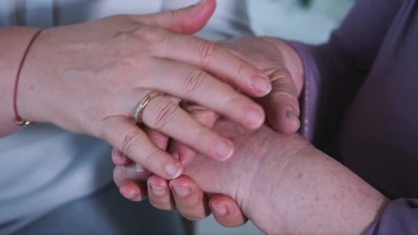 Close up. Caring elderly mother woman worried taking supporting and gently stroking hand of her senior grandmother nanny give empathy care love, grandparents family together hope understanding concept — Stock Video