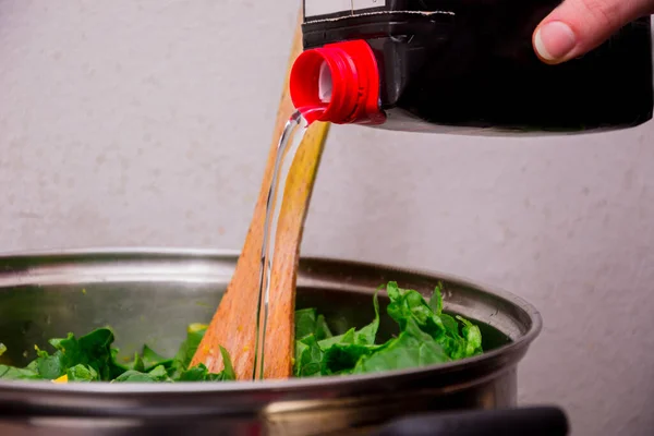 Pouring Some Transparent Juice Black Box Green Salad — Stock Photo, Image