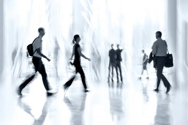 Group of people in the lobby business center and blue tonality — Stock Photo, Image