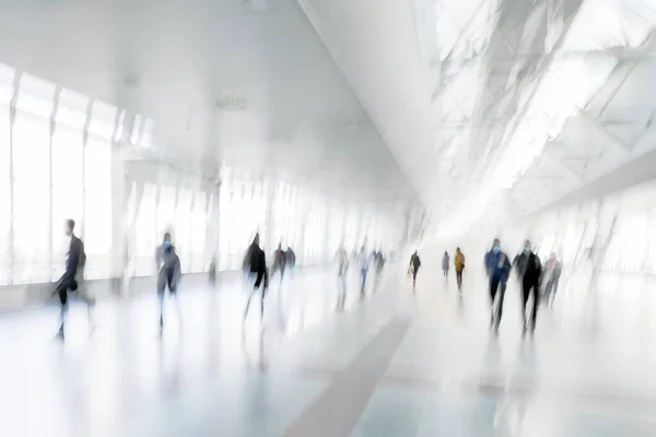 abstract image of people in the lobby of a modern transport center airport bus and train station