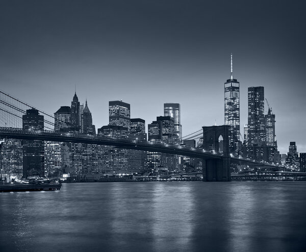 Panoramic view New York City Manhattan downtown skyline at night with skyscrapers and blue tonality